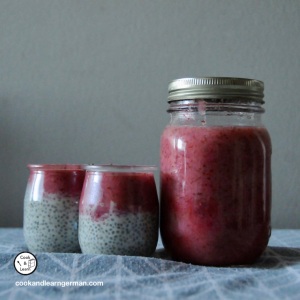 jar or red fruit jelly and two small pots of red fruit jelly on top of chia pudding